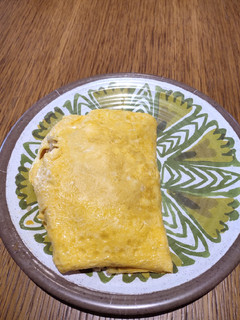 A picture of Fried Rice covered with Egg.