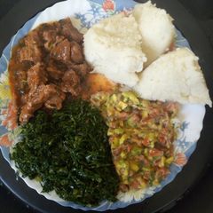 A picture of Ugali and greens with fried meat and kachumbari#4weekchallenge.