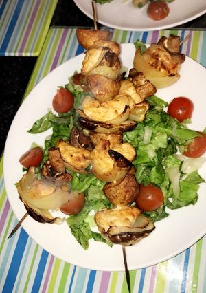 A picture of Healthy chicken skewers served with a salad.