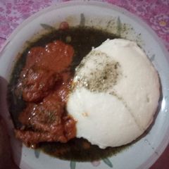 A picture of Semolina and miyan kuuka with cow meat stew.