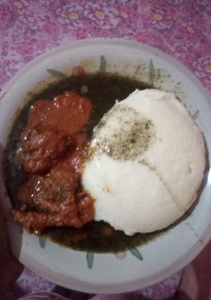 A picture of Semolina and miyan kuuka with cow meat stew.