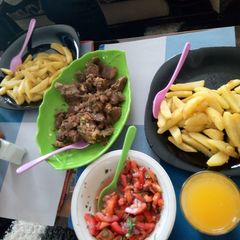 A picture of Boiled meat and pan fried potatoes with kachumbari.