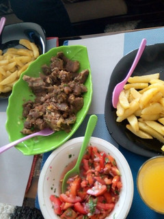 A picture of Boiled meat and pan fried potatoes with kachumbari.