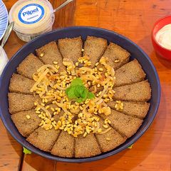 A picture of Kibbee Busta (Baked Kibbee with onion and pine nuts).