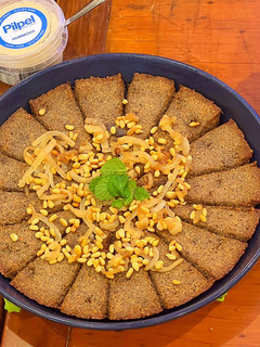 A picture of Kibbee Busta (Baked Kibbee with onion and pine nuts).
