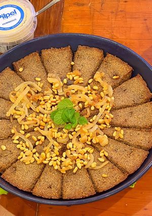 A picture of Kibbee Busta (Baked Kibbee with onion and pine nuts).