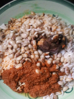 A picture of Rice and beans with stew.