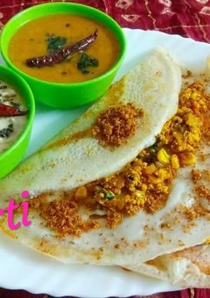 A picture of Paneer Corn Dosa with podi, Sambhar and Coconut chutney.