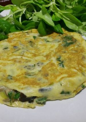 A picture of Wild mushroom omelette with cilantro.