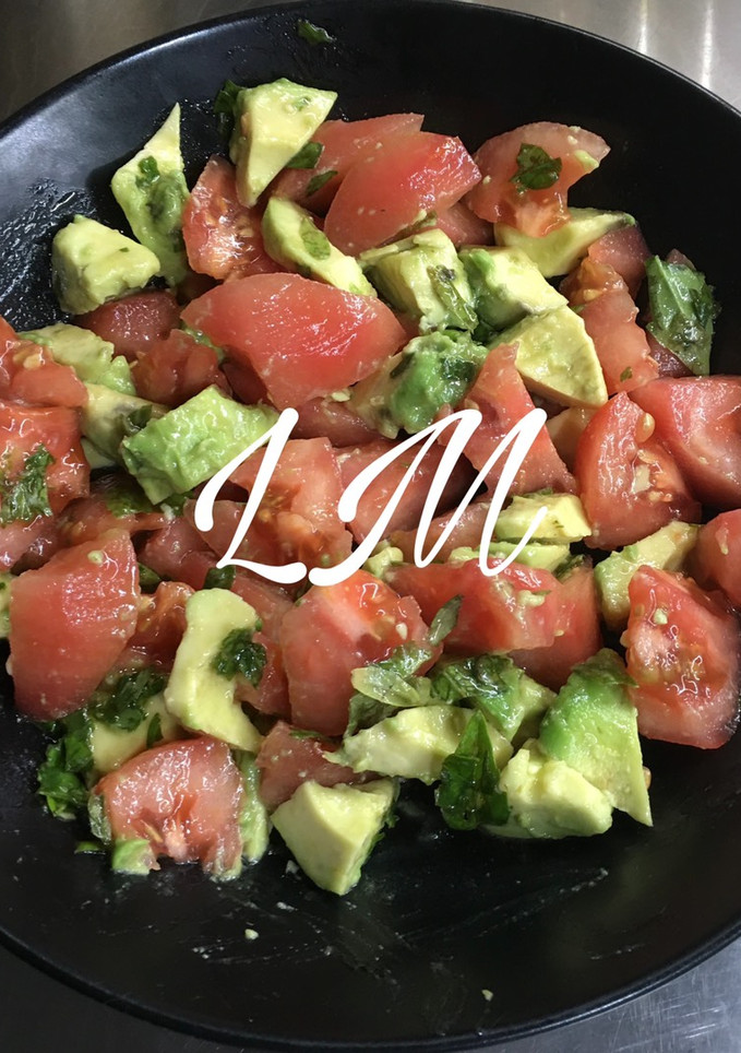Una foto de Ensalada de tomate y aguacate con albahaca