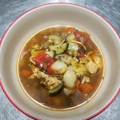 A picture of Chicken vegetable soup with gnocchi.