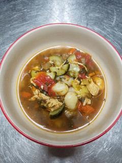 A picture of Chicken vegetable soup with gnocchi.