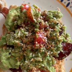 A picture of Avocado Egg in the Middle with Bacon.