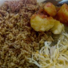 A picture of Pilau with potatoes, greengrams and salad.