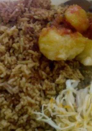 A picture of Pilau with potatoes, greengrams and salad.