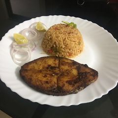 A picture of Mexican rice with fish.
