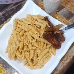 A picture of Penne alfredo pasta.