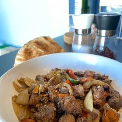 A picture of Lamb meat with veggies.