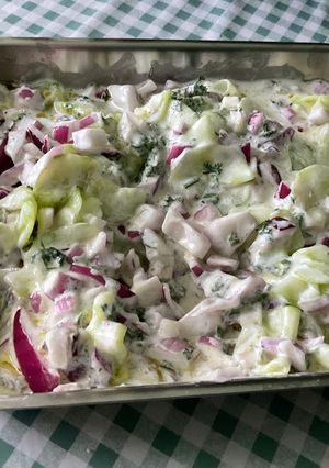 Une photo de Salade de concombre mariné à la crème, persil et oignon rouge