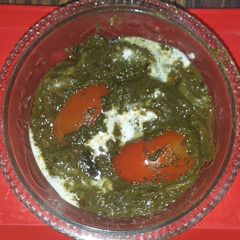 A picture of Palak tomato curry with cream.