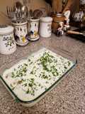 Slices of chicken with potatoes and white sauce