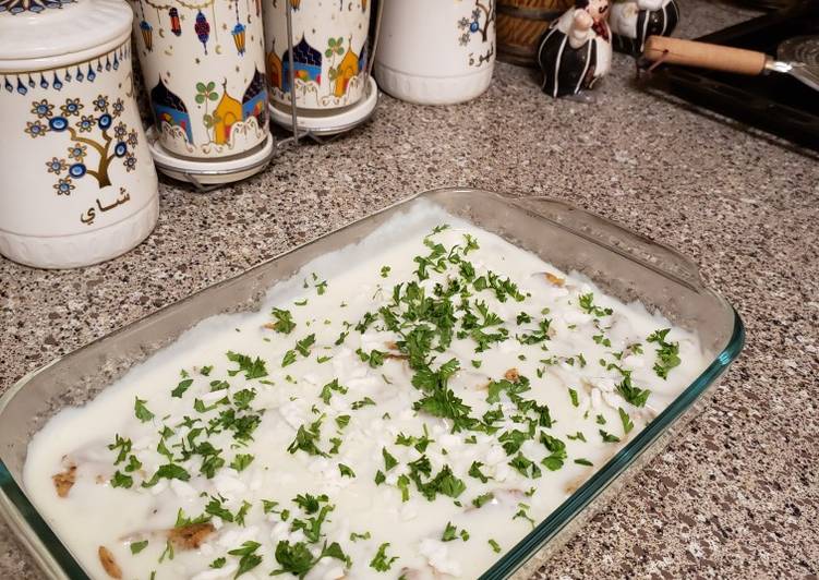 Slices of chicken with potatoes and white sauce