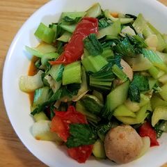 A picture of Sautéd baby bok choy with tomatoes.