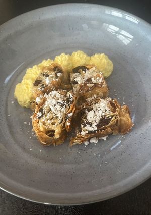 A picture of Rum Glazed Almond & Raisin Filo Roll with Rum Cream.