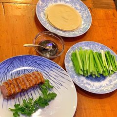 A picture of Duck pancakes with hoi sin and cucumber.