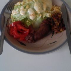 A picture of Green salad with wors and veggies.