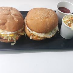 A picture of Coleslaw and egg burger.