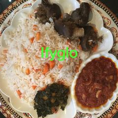 A picture of Rice with goat meat tomato sauce.
