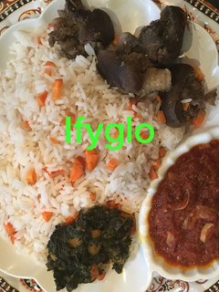 A picture of Rice with goat meat tomato sauce.