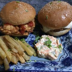 A picture of Zinger burger with mayo salad and French fries.