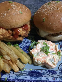 A picture of Zinger burger with mayo salad and French fries.