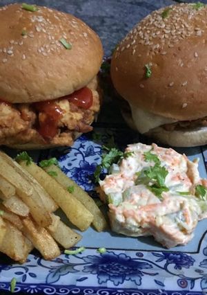 A picture of Zinger burger with mayo salad and French fries.