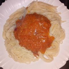 A picture of Spaghetti and homemade tomato sauce.