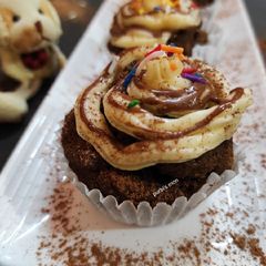 Chocolate cup cake with vanilla butter cream and chocolate sauce A picture of Chocolate cup cake with vanilla butter cream and chocolate sauce.