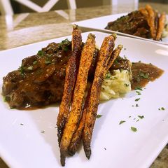 A picture of Salisbury steak with mushroom gravy.