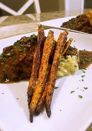 A picture of Salisbury steak with mushroom gravy.