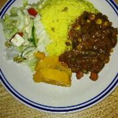 A picture of Homemade beef kidney stew and yellow rice.