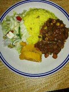 A picture of Homemade beef kidney stew and yellow rice.
