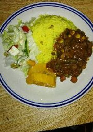 A picture of Homemade beef kidney stew and yellow rice.