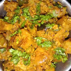 A picture of Dry brinjal and potatoes curry.