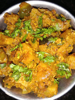 A picture of Dry brinjal and potatoes curry.