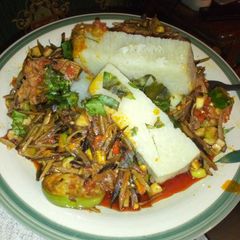 A picture of Chicken ugba forest with boiled yam.