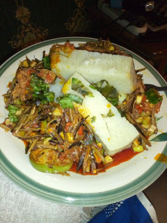A picture of Chicken ugba forest with boiled yam.