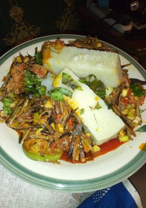 A picture of Chicken ugba forest with boiled yam.