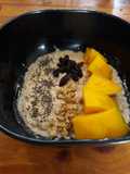 Oatmeal with Whey Protein, chia seed, granola and mango sliced