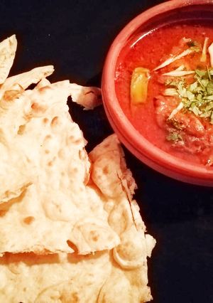 A picture of Aloo Chicken salan with Nan.